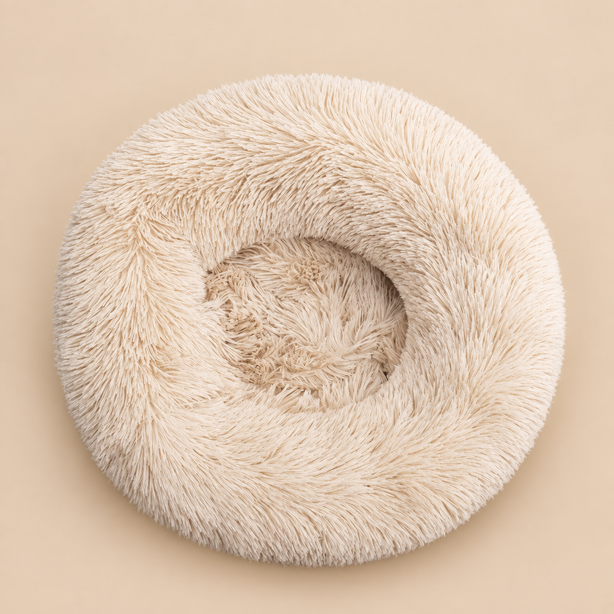 Round light brown plush pet bed on warm beige background